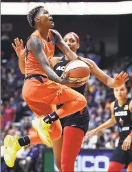  ?? Sean D. Elliot / The Day via AP ?? Connecticu­t Sun guard Courtney Williams puts up her shot as she is fouled by Las Vegas Aces forward A'ja Wilson.