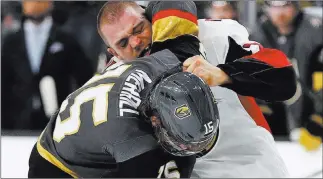  ??  ?? John Locher Golden Knights defenseman Jon Merrill fights with Ottawa Senators defenseman Mark Borowiecki in the first period of Vegas’ 4-3 overtime victory Sunday at T-mobile Arena.