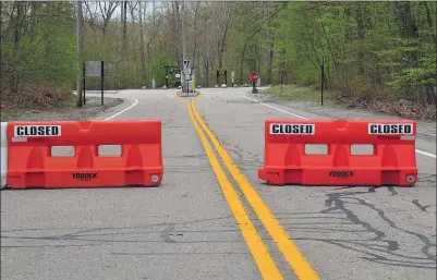  ?? Photo by Ernest A. Brown ?? Although barricades were still up blocking entrance to Lincoln Woods State Park in Lincoln Friday afternoon, the park will reopen to visitors on Saturday.