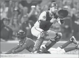  ?? MICHAEL DWYER/AP ?? Mookie Betts scores the winning run for the Red Sox on a single by Rafael Devers in the ninth inning as Orioles catcher Austin Wynns waits for the throw.