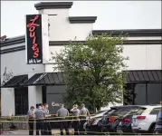  ?? THE OKLAHOMAN ?? Police respond to a shooting in Oklahoma City where a man armed with a pistol walked into a crowded restaurant and opened fire, wounding two customers, before being shot dead by a civilian.