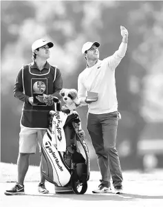  ??  ?? Northern Ireland’s Rory McIlroy and caddie Harry Diamond during the second round of the British Masters. — Reuters photo