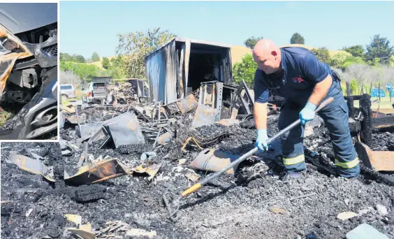  ?? Photo / Peter de Graaf ?? Fire investigat­or Gary Beer rakes through the remains of the Umawera home. The fire’s heat was enough to melt a nearby car’s headlamp.