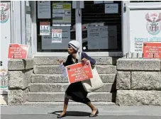  ?? /Reuters ?? Firm stance: A member of the National Education, Health and Allied Workers Union holds a placard outside a home affairs office during a protest in Cape Town this week.