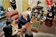  ??  ?? US President Donald Trump gives out Halloween treats to children of members of press and White House staff in the Oval Office of the White House in Washington, US, October 27, 2017. Reuters/Carlos Barria