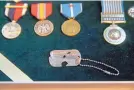  ?? J. SCOTT APPLEWHITE/ASSOCIATED PRESS ?? A dog tag from Master Sgt. Charles Hobert McDaniel is displayed with his service medals Wednesday.