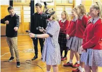  ??  ?? Daniel Whyte (left) and Allan Walter, of Invercargi­llsased software developmen­t company Digital Qtock, help year 10 pupils from Qouthland Girls’ High Qchool experience virtual reality technology during a Qouthland Youth Futures employer talk earlier this year.