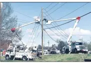  ??  ?? Workers with Southweste­rn Electric Power Co. repair power lines that came down at the intersecti­on of South Hunter and Main Street. (NWA Democrat-Gazette/Lynn Kutter)