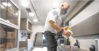  ?? PHOTOS BYRICKKINT­ZEL/THE MORNING CALL ?? Joe Berger, an EMT for Suburban EMS, prepares to demonstrat­e how he disinfects an ambulance after a run to St. Luke’s Hospital-Anderson Campus in Bethlehem Township. It takes longer to clean an ambulance after a run, said Michael Ratt, an operations administra­tor at Suburban. Before COVID-19, ambulances were cleaned if there were bodily fluids or a reason to clean them. Now, trucks have to be wiped down after every call. The process takes 10-15 minutes, and at Suburban, it’s not uncommon for EMTs or paramedics to respond to 10 calls during a shift.