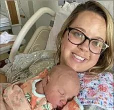  ?? Russ Brown via AP ?? Sara Brown holds her newborn daughter, Suzie, at a hospital in Union City, Tenn. Ms. Brown decided she would wait until the baby was born to get vaccinated. But in June, she got COVID-19, landing in an intensive care unit for five days, on oxygen and struggling to breathe.