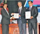  ??  ?? Sri Lanka Standards Institute (SLSI) Director General Gamini Dharmaward­ena presents the ISO Certificat­e to IPM Sri Lanka President Ajantha Dharmasiri and IPM Sri Lanka Chief Operating Officer P. G. Tennakoon