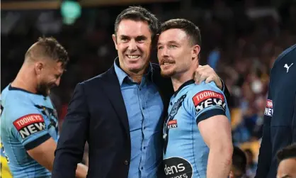  ?? Photograph: Dave Hunt/ AAP ?? NSW coach Brad Fittler hugs Damien Cook after NSW Blues’ State of Origin series-clinching victory in game two.