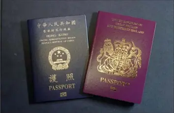  ?? Kin Cheung/Associated Press ?? A British National Overseas passport, right, and a Hong Kong Special Administra­tive Region of the People’s Republic of China passport.