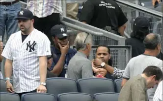  ?? BILL KOSTROUN, THE ASSOCIATED PRESS ?? Fans react as a girl is tended to before she is carried out of the seating area after being hit by a line drive in the fifth inning of a baseball game between the New York Yankees and Minnesota Twins on Wednesday.