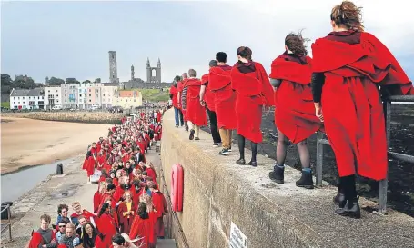  ?? Picture: PA. ?? St Andrews University students taking part in their annual Pier Walk.