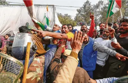  ?? Arun Kumar / AFP via Getty Images ?? Police try to stop residents of Singhu, India, on the outskirts of New Delhi, as they clash with farmers who were continuing to protest the government’s recent agricultur­al reforms and were blocking a highway.