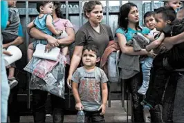  ?? SPENCER PLATT/GETTY ?? Central American women and children, many fleeing violence, arrive at a bus station last week after being released by Customs and Border Protection in McAllen, Texas.