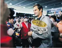  ?? REMY STEINER/GETTY IMAGES ?? Roger Federer arrives in Switzerlan­d with his trophy after winning the Australian Open men’s singles tennis final.