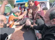  ?? AFP ?? Medics tend to an Iraqi protester injured at a demonstrat­ion outside the southern port of Umm Qasr on Tuesday, after security forces attempted to break up crowds blocking the road to the port.