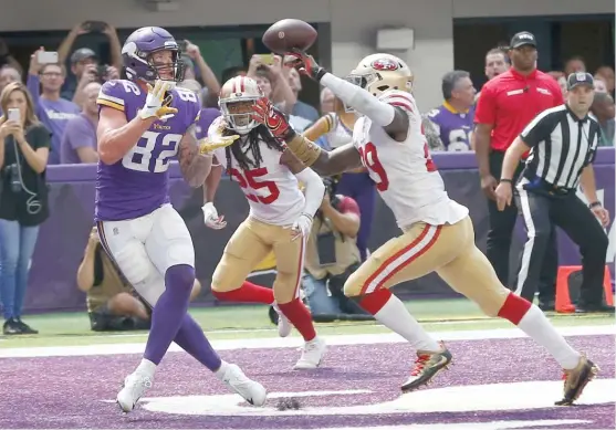  ?? JIM MONE/AP ?? Vikings tight end Kyle Rudolph hauls in a touchdown pass behind 49ers safety Jaquiski Tartt (right) during the third quarter Sunday in Minneapoli­s.
