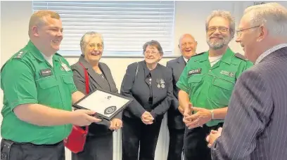  ??  ?? ●● Mark Boyle receiving his award for his service with St John Ambulance