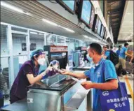  ?? ZHANG XIAOMIN / CHINA DAILY ?? An employee of China Railway No 9 Group shows his health kit to an airport staff before boarding a flight to Belgrade, Serbia, in Dalian, Liaoning province, on Saturday.