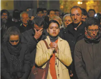  ?? CHRISTOPHE ENA ASSOCIATED PRESS ?? Catastroph­és, les Parisiens ont regardé les flammes ravager la célèbre cathédrale.