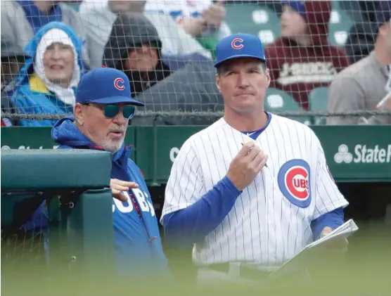  ?? AP ?? Pitching coach Jim Hickey (right, with manager Joe Maddon) has been with the Cubs one year, replacing the fired Chris Bosio, but there are indication­s he might not be back.