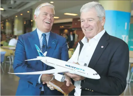  ?? JIM WELLS ?? WestJet Airlines president and CEO Gregg Saretsky, left, and co-founder and board chairman Clive Beddoe, with a model of the Boeing 787 Dreamliner in Calgary on Tuesday. WestJet announced a definitive purchase agreement with Boeing for up to 20 Boeing...