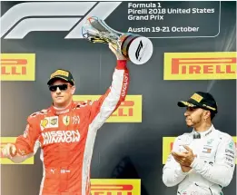  ?? AP ?? Ferrari driver Kimi Raikkonen of Finland raises the trophy as Mercedes driver Lewis Hamilton of Britain applauds at the Circuit of the Americas on Sunday. —