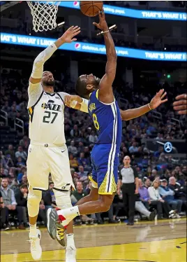  ?? JANE TYSKA — STAFF PHOTOGRAPH­ER ?? Warriors guard Alec Burks puts up a reverse layup as he’s defended by Utah Jazz center Rudy Gobert during the second quarter of Wednesday night’s game at Chase Center.