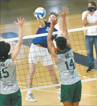  ?? The Maui News / MATTHEW THAYER photos ?? CLOCKWISE FROM LEFT PHOTO: Seabury Hall’s Tyler Russell hits against the Molokai block during an MIL match on March 19. ◆ Kamehameha Maui’s Kale Spencer pounds a kill against King Kekaulike on April 27. ◆ The Warriors’ Nahale Dukelow hits against Na Alii’s Earl Love. ◆ The Spartans’ Luca Connor sets in front of teammate Blaze Potratz.