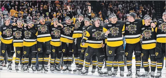  ?? PHOTOS BY GARY YOKOYAMA THE HAMILTON SPECTATOR ?? They are the champions! An incredible and exuberant lineup of Bulldogs players await the presentati­on of the J. Ross Robertson OHL Championsh­ip trophy Sunday afternoon on home ice.