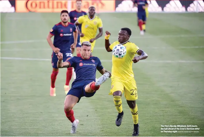  ?? EMILEE CHINN/GETTY IMAGES ?? The Fire’s Djordje Mihailovic (left) boots the ball ahead of the Crew’s Harrison Afful on Thursday night.