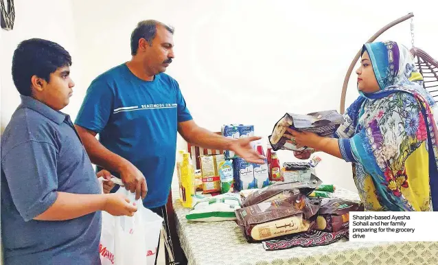  ??  ?? Sharjah-based Ayesha Sohail and her family preparing for the grocery drive