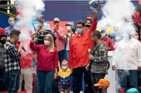  ?? AP ?? Venezuela’s President Nicolas Maduro, right, and first lady Cilia Flores, wave at supporters during a campaign rally.