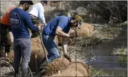  ?? BEN HASTY — MEDIANEWS GROUP ?? Berks County Conservati­on District employees Juan Bol, left, and Evan Corondi, put live stakes in the coir logs along the Valley Run Creek at Frontier Pastures, a farm in Washington Township.