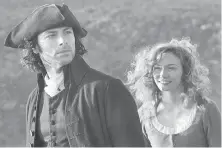  ??  ?? Aidan Turner and Eleanor Tomlinson star in Poldark, which begins its second season Sunday on Masterpiec­e.
