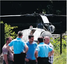  ?? GEOFFROY VAN DER HASSELT / AFP / GETTY IMAGES ?? This picture taken Monday in Gonesse, north of Paris, shows police near a French helicopter Alouette II abandoned by French armed robber Redoine Faïd after his dramatic escape from prison in Reau.