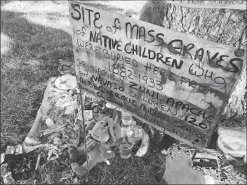  ?? SUSAN MONTOYA BRYAN/AP ?? A MAKESHIFT MEMORIAL FOR THE DOZENS of Indigenous children who died more than a century ago while attending a boarding school that was once located nearby is displayed under a tree at a public park in Albuquerqu­e, N.M., on July 1, 2021.