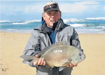  ??  ?? CAUGHT AND RELEASED: Terry Stewart with a bronze bream of 4.1kg caught during the most recent Port Alfred Rock and Surf Round Robin