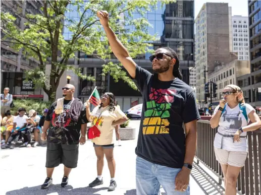  ?? ANTHONY VAZQUEZ/SUN-TIMES PHOTOS ?? A man raises his fist during the March for Us rally celebratin­g Juneteenth and the life of activist Caleb Reed on Saturday at Daley Plaza.