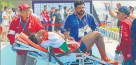  ?? PTI ?? ▪ Rower Dushyant Chauhan being taken for medical help after falling sick during the medal ceremony.