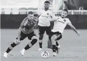  ?? ANDREW ULOZA FOR THE MIAMI HERALD ?? Inter Miami midfielder Jean Mota, right, battles for control in the scrimmage against D.C. United on Saturday.