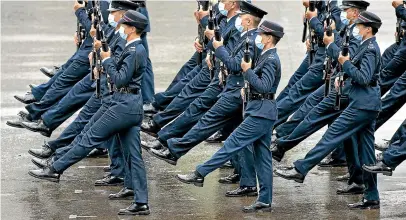  ?? AP ?? Hong Kong police show their new goose-step marching style on the National Security Education Day at a police school in Hong Kong.