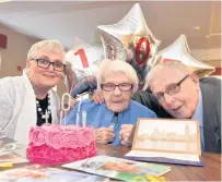  ??  ?? >
Left: Nell Jinks celebratin­g her 107th birthday this week with her son Bernard and his wife Eileen. >
Right: With her card from the Queen