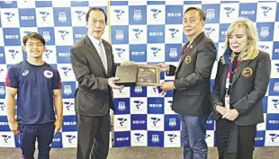  ??  ?? PHILIPPINE Olympic Committee President Rep. Abraham “Bambol” Tolentino presents a plaque of appreciati­on to Yoshihito Okinaga, President and CEO of Teikyo University where gymnast Carlos Yulo (left) has trained all these years. At right is Gymnastics Associatio­n of the Philippine­s President Cynthia Carrion Norton.