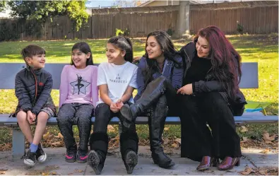  ?? Santiago Mejia / The Chronicle ?? Danyal (left), Iman, Jennah and Diana sit with their mother, Habiba Nasseri, at a park in Santa Clara. Habiba Nasseri participat­ed in a study to share her genetic data with UCSF and Color Genomics to help expand research on genetic variants for disease...