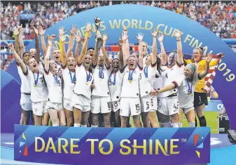  ?? Alessandra Tarantino / Associated Press ?? The United States soccer team celebrates with the trophy after winning the Women’s World Cup final match over the Netherland­s in France this month.