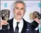  ?? AP ?? Alfonso Cuaron with Best Film and Best Director awards.